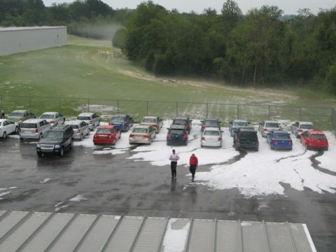 1971 Ford Ranchero - Hail has accumulated in a parking lot, covering many vehicles and the ground.