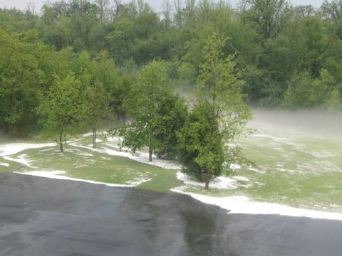 1971 Ford Ranchero - A scene of a driveway and lawn covered in hail, with trees and mist in the background.