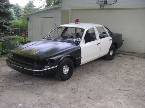 1997 Ford Crown Victoria - This unfinished police car project sits in front of a garage, awaiting further work.