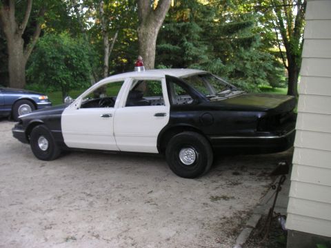 1997 Ford Crown Victoria - This 1997 Ford Crown Victoria, painted in a black and white two-tone scheme, appears to be a former police vehicle.