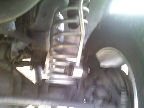 1998 Jeep Cherokee - Vehicle's rear suspension system, focusing on the coil spring and shock absorber assembly.