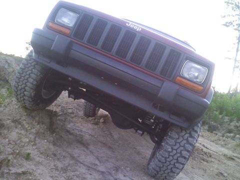 1998 Jeep Cherokee - This 1998 Jeep Cherokee is shown flexing its suspension while navigating a steep dirt incline.