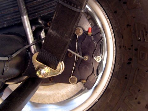 1996 Ford Bronco - Vehicle's rear brake caliper and suspension components are shown in this close-up detail.