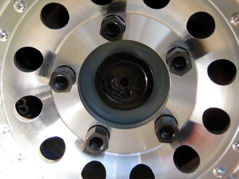1996 Ford Bronco - A detailed view of a vehicle's wheel hub assembly, showing lug nuts and the center cap.