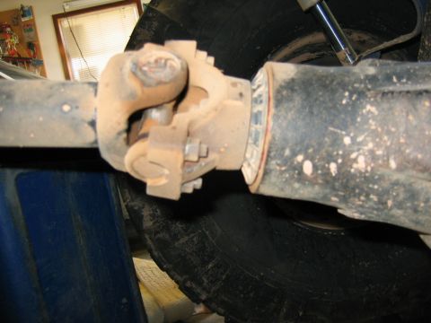 1992 Ford Mustang - Driveshaft U-joint connection detail, showing wear and dirt on the component.