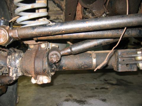 1992 Ford Mustang - This image shows the underside of a vehicle, focusing on the steering and suspension system with visible rust and wear.