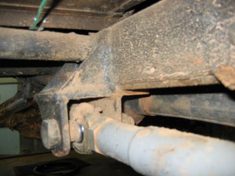 1992 Ford Mustang - Undercarriage view of a vehicle's frame and suspension system, covered in dirt and grime.