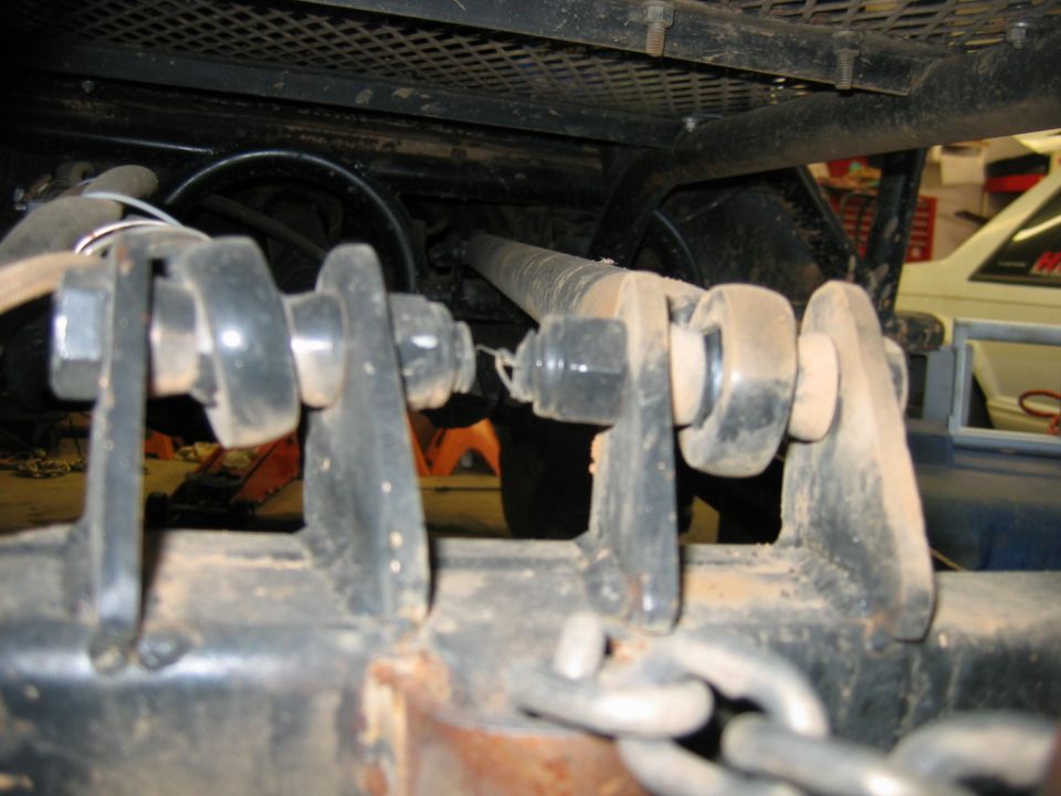 Close-up of trailer hitch mechanism with chains and bolts