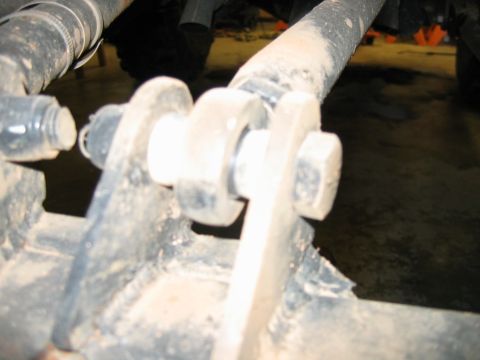 1992 Ford Mustang - A close-up view of a vehicle's suspension component, showing bolted connections.