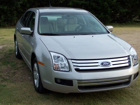 2008 Ford Fusion - This silver 2008 Ford Fusion is shown from a 3/4 front angle, highlighting its grille and headlights.