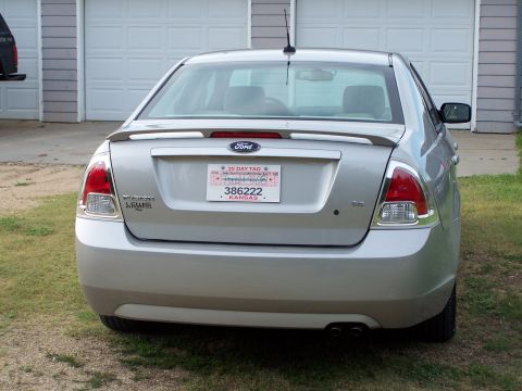 2008 Ford Fusion - The rear of a silver Ford Fusion is shown with a Kansas license plate and a spoiler.