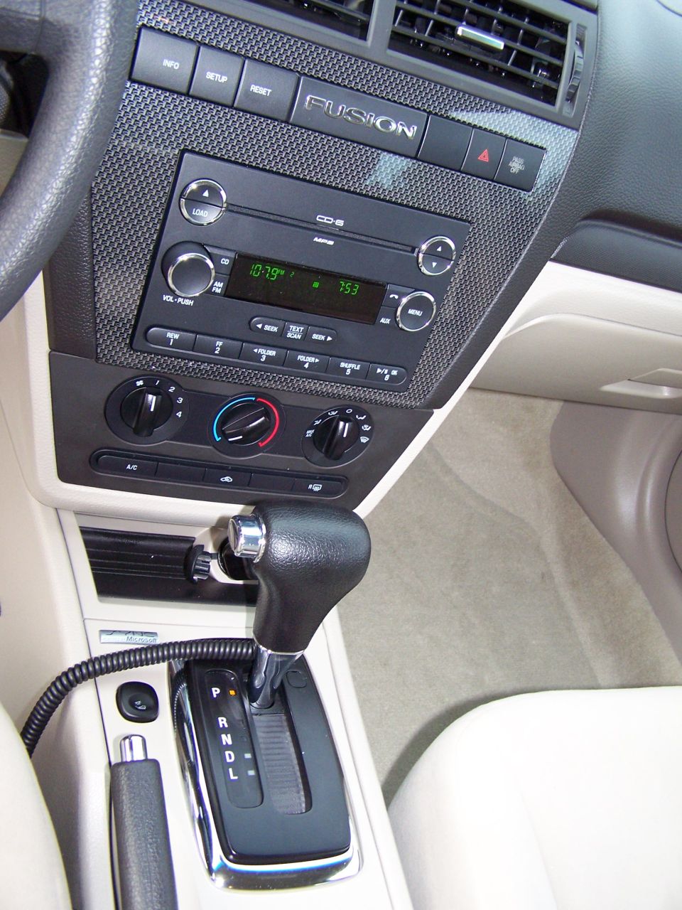 Ford Fusion center stack with radio, climate dials, and automatic shifter