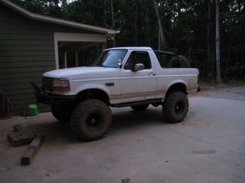 1996 Ford Bronco - This modified Ford Bronco features large tires and a custom front bumper, suggesting it's built for off-road use.