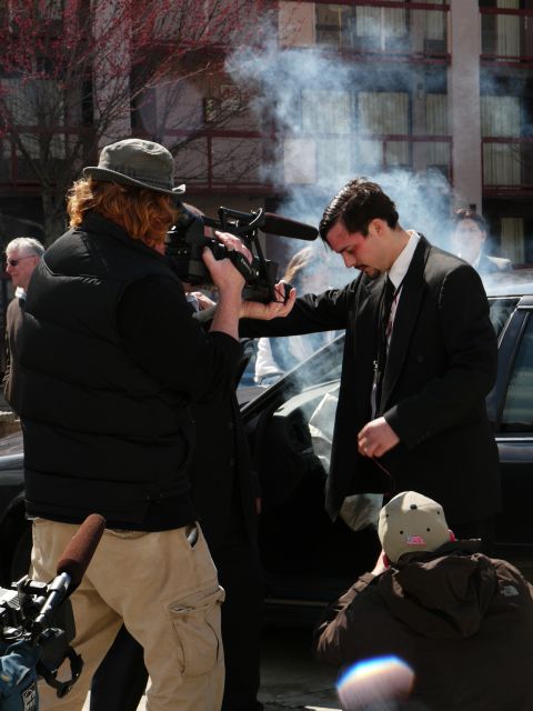 1985 Ford LTD Crown Victoria - A film crew captures a dramatic scene involving a man in a suit and a car, with smoke effects.