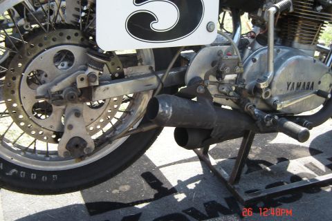 2006 Honda CBR-RR - Close-up view of a Yamaha motorcycle's rear section, showing the wheel, exhaust pipes, and engine detail.