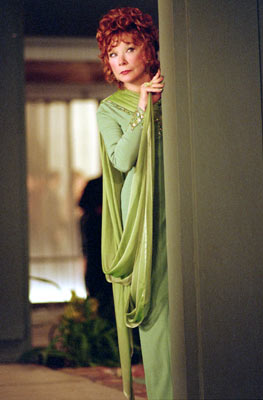 1991 Ford Crown Victoria - Woman in a green dress peeks from behind a curtain, with a watermark at the bottom.