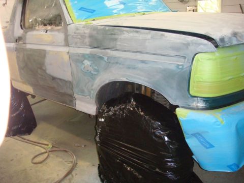 1996 Ford Bronco - This 1996 Ford Bronco is undergoing body repair, with primer and masking tape applied to the fender and door.