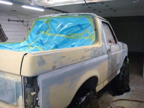 1996 Ford Bronco - This vehicle is undergoing body repair work, with masking tape and plastic covering the windows.