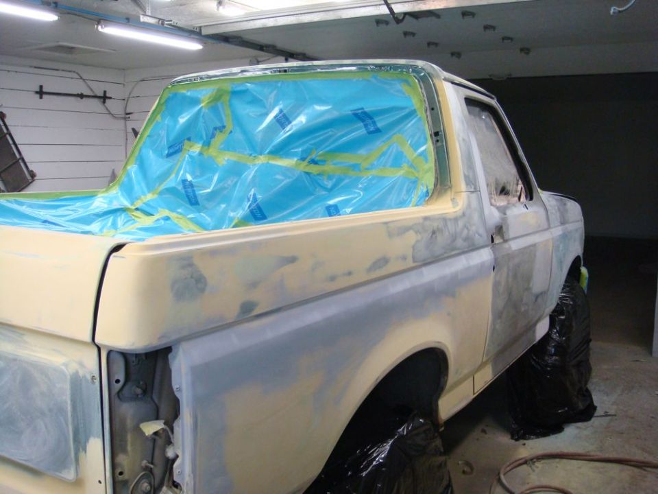 Ford Bronco body being prepped for paint, windows taped off