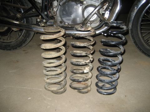 1995 Ford Bronco - Comparison of three suspension springs, one appears to be painted black.