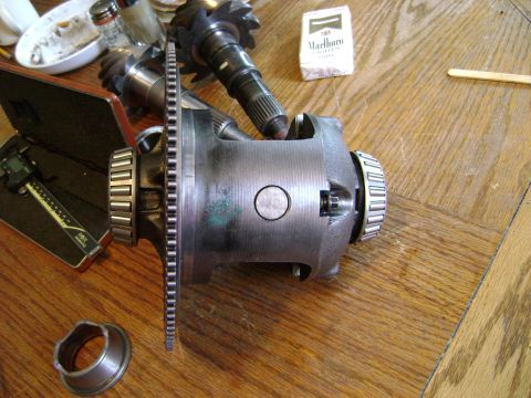 1994 Ford Bronco - Close-up of a differential carrier and associated gears, with a caliper and a pack of Marlboro cigarettes nearby.