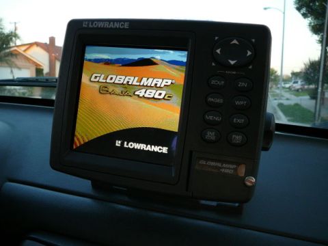 1988 Ford Bronco - A Lowrance GPS unit is displayed on the dashboard of a vehicle, showing a desert landscape on its screen.