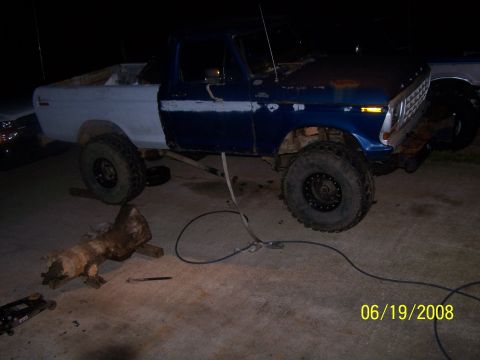 1979 Ford F-150 - 1979 Ford F-150 truck undergoing repairs, with transmission removed and placed on the ground.