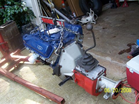 1979 Ford F-150 - A Ford V8 engine and transmission assembly is shown, suspended by chains in a garage setting.