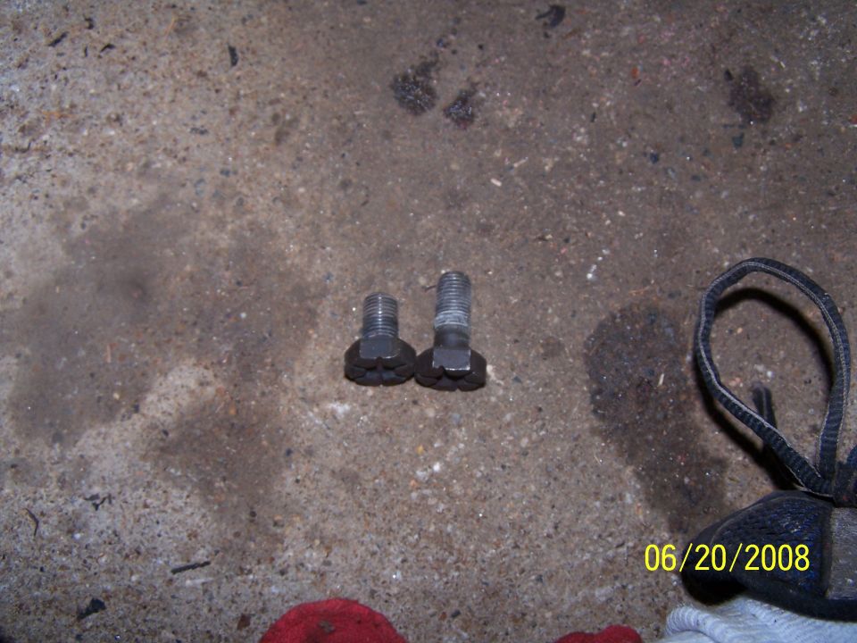 Two bolts on a concrete floor with a date stamp of 06/20/2008