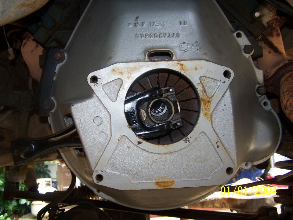 Close-up of a Ford truck transmission bell housing with clutch visible. Part number D7TA7505AD stamped on housing