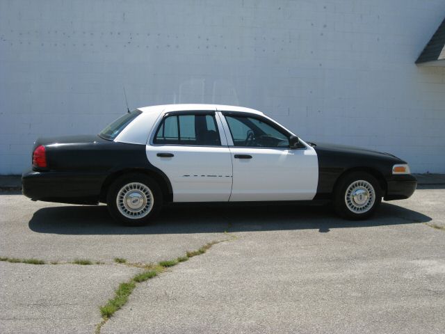 Side view of a black and white Ford Crown Victoria sedan.