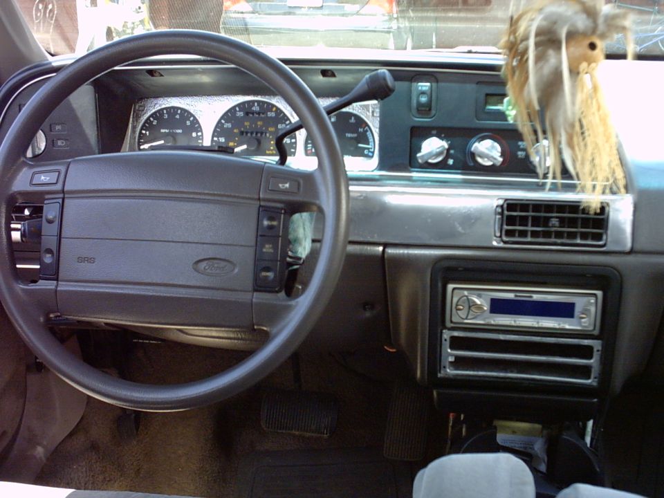 Ford vehicle interior dashboard with steering wheel gauges and aftermarket stereo
