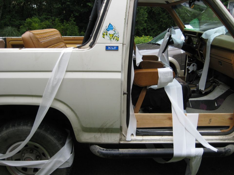 White Ford Bronco covered in streamers, interior visible.