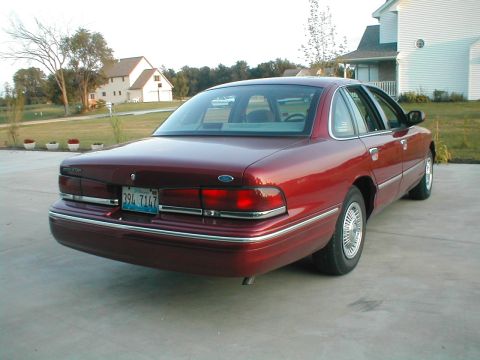 1996 Ford Crown Victoria - Rear 3/4 view of a red 1996 Ford Crown Victoria sedan with license plate 394 7147.