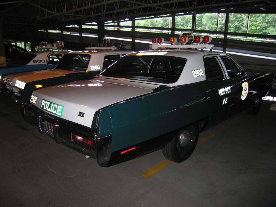 Rear view of green-and-white POLICE sedan 2902 marked MCY PCT 2 indoors