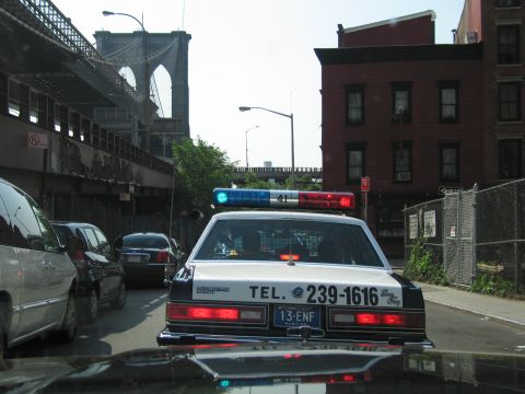 1991 Ford LTD Crown Victoria - Rear view of a white-and-black police cruiser with light bar and Connecticut 13-ENF plate stopped near the Brooklyn Bridge.