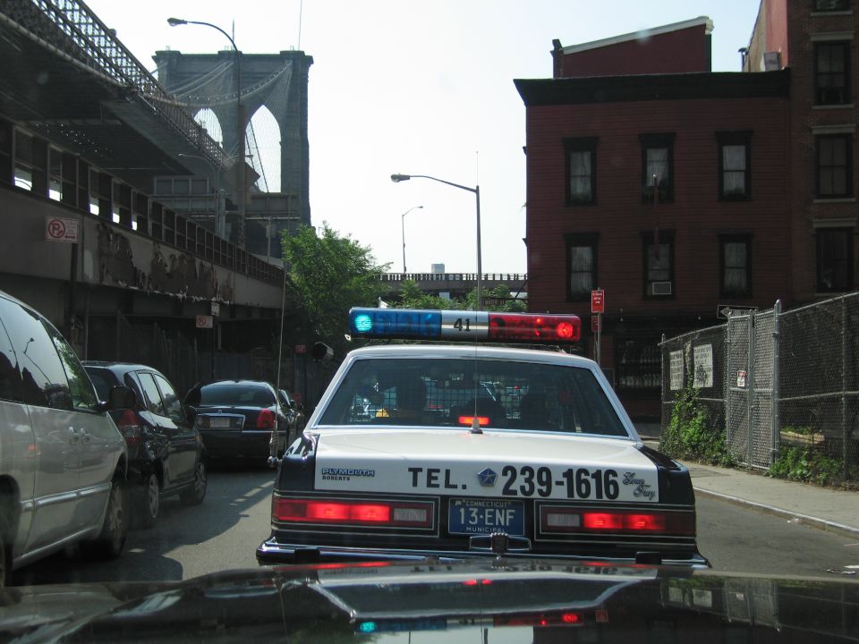 Rear of police sedan TEL. 239-1616 with Connecticut 13-ENF plate, Brooklyn Bridge backdrop