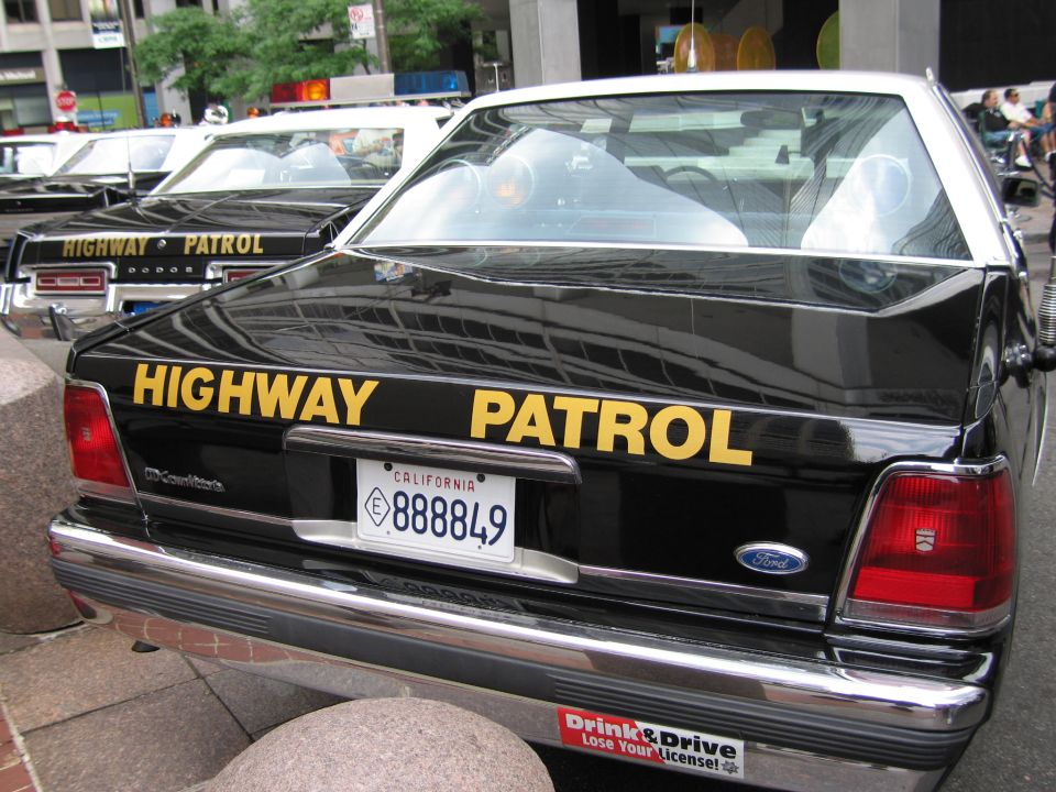 Rear of black Ford Highway Patrol cruiser, California plate 888849, at car show