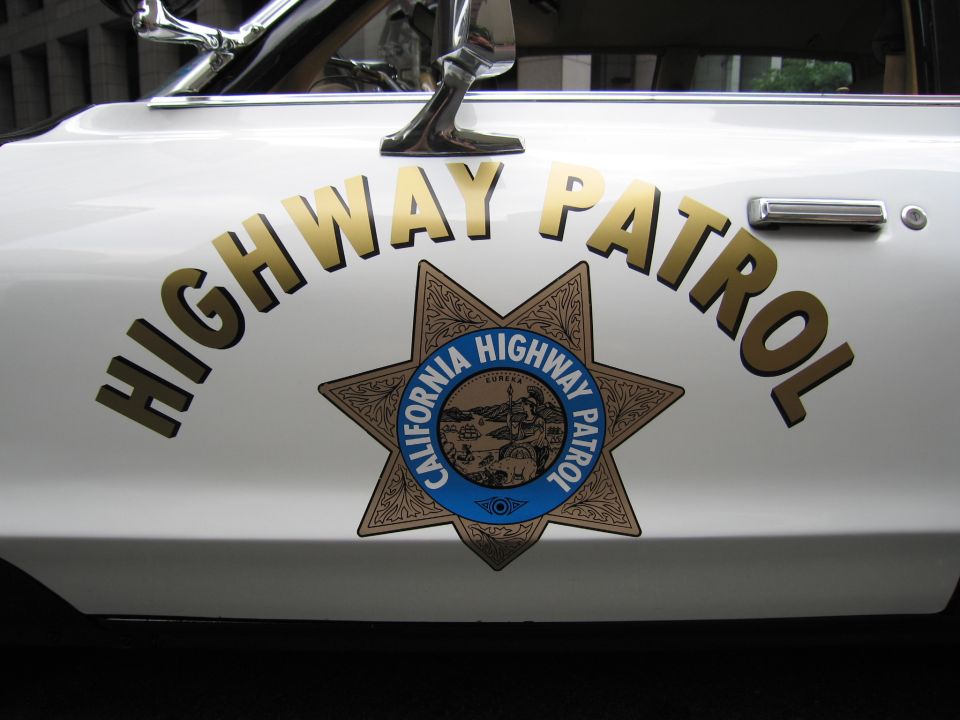 Close-up of white California Highway Patrol door with HIGHWAY PATROL star emblem