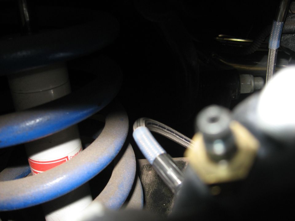 Blue coilover shock absorber with braided brake line