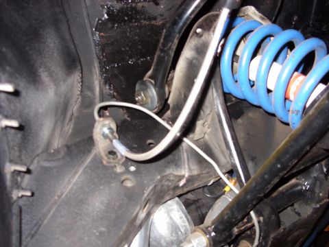 1978 Ford Mustang II - Detail of a vehicle's suspension system, likely showing brake components and a coil spring.