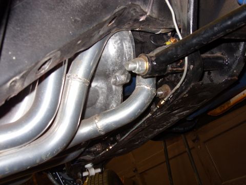 1978 Ford Mustang II - Close-up of the exhaust system and suspension components on the underside of a vehicle.