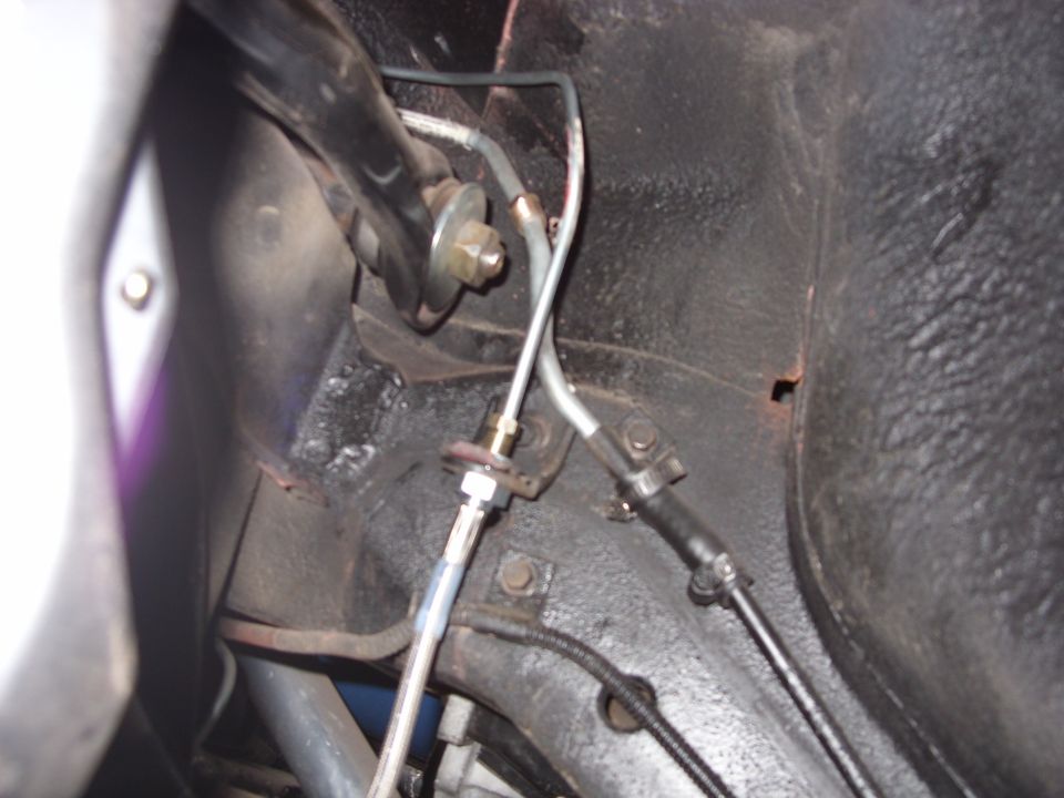 Close-up of brake lines and suspension components in a vehicle's undercarriage