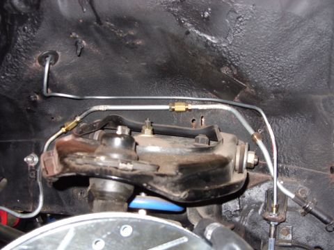 1978 Ford Mustang II - Close-up view of front suspension components and brake lines, likely part of a brake upgrade.