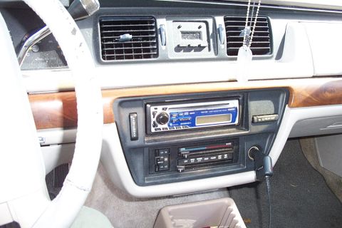1992 Ford Crown Victoria - The interior of a 1992 Ford Crown Victoria shows its dashboard with wood grain accents and an aftermarket stereo system.