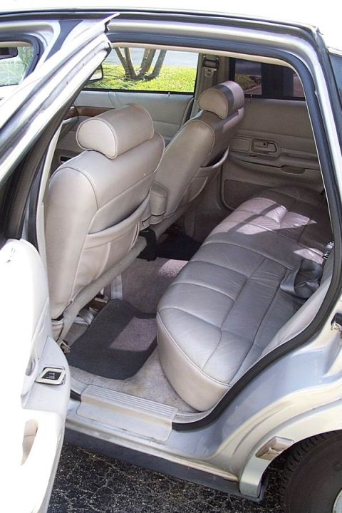 1992 Ford Crown Victoria - The spacious rear interior of a 1992 Ford Crown Victoria features comfortable gray leather seating and ample legroom.