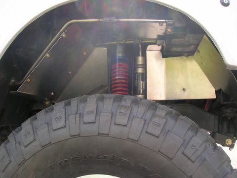 1996 Ford Bronco - Custom suspension components are visible behind the wheel well of an off-road vehicle.