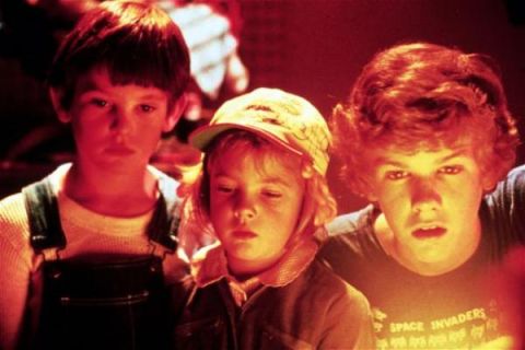 1991 Ford Crown Victoria - A group of children are illuminated by a warm, reddish light as they focus on an unseen object.