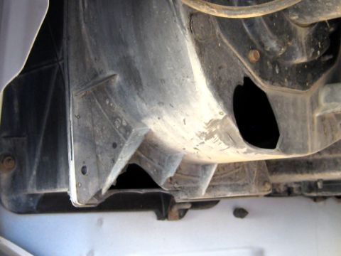 1996 Ford Bronco - This is a close-up view of the underside of a vehicle's fender liner, showing a section of the wheel well.