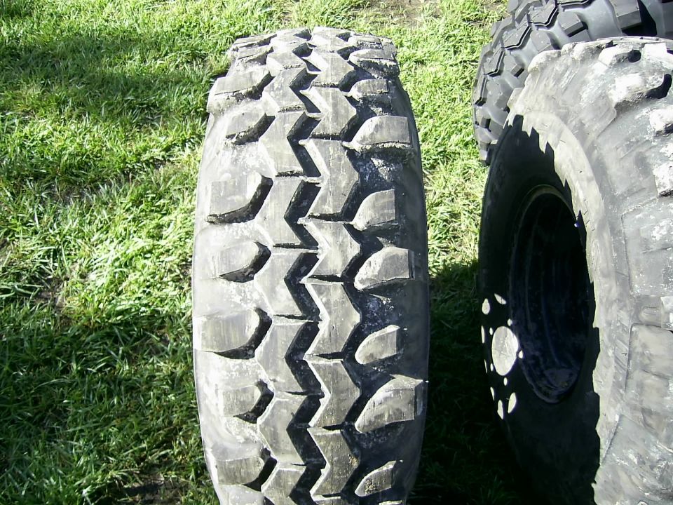 Close-up of off-road tire tread with another tire visible